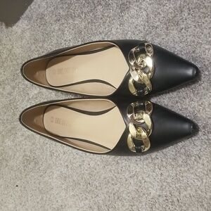 Black flats with silver detail.